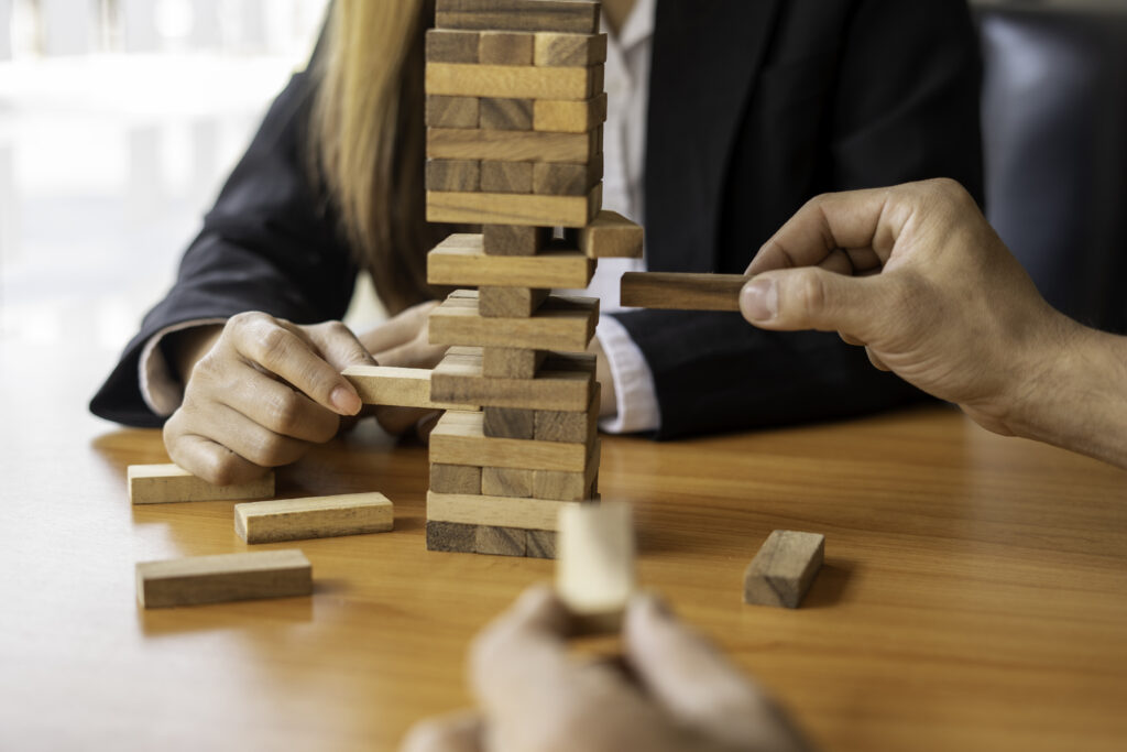 A businesswoman pulls a wooden block in the middle of the floor. It is like managing business risks with strategies. and project management the best of the business